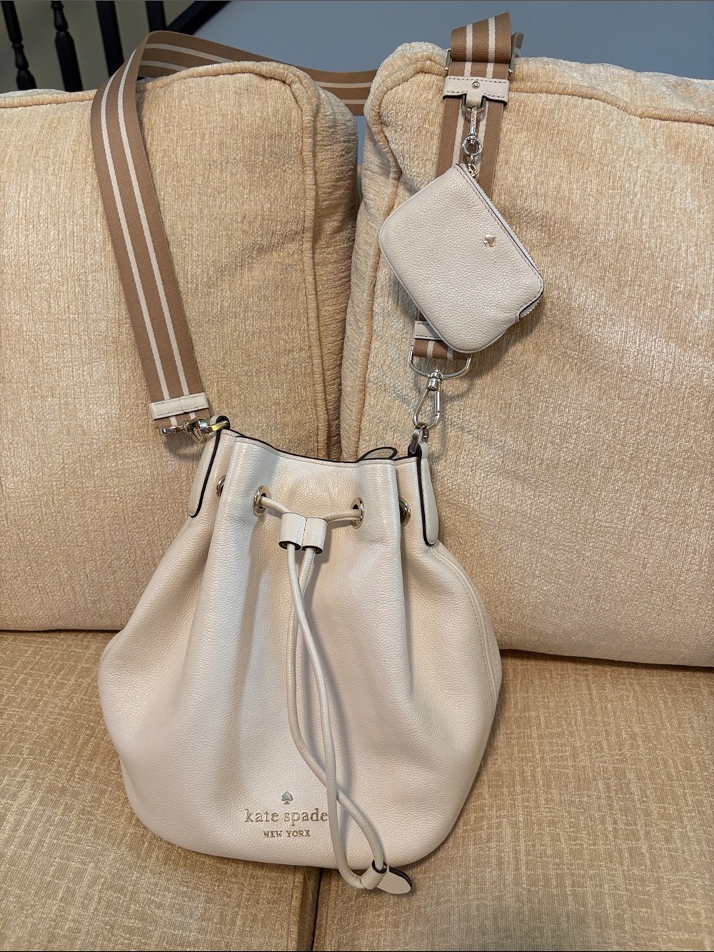 kate spade cream leather drawstring bucket bag with striped strap and pouch